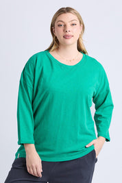 A model wearing the Fundamental Annie 3/4 Sleeve Cotton Tee in colour Turquoise (Green), from the front, cropped image
