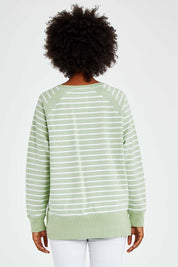 Model Olivia wearing size 10 of the Fundamental Sydney Crew in colour Greenstrip (Green), from the back