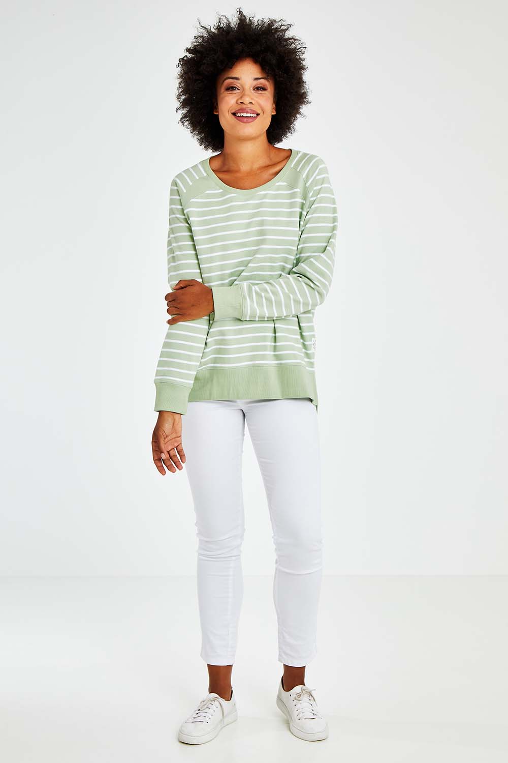 Model Olivia wearing size 10 of the Fundamental Sydney Crew in colour Greenstrip (Green), from the front, showing the whole outfit