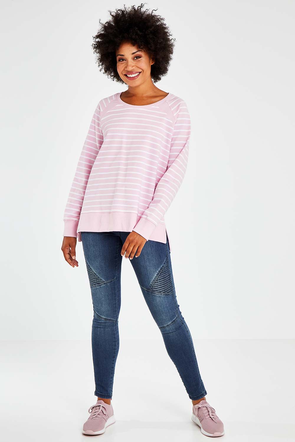 Model Olivia wearing size 10 of the Fundamental Sydney Crew in colour Pinkstripe (Pink), from the front, showing the whole outfit