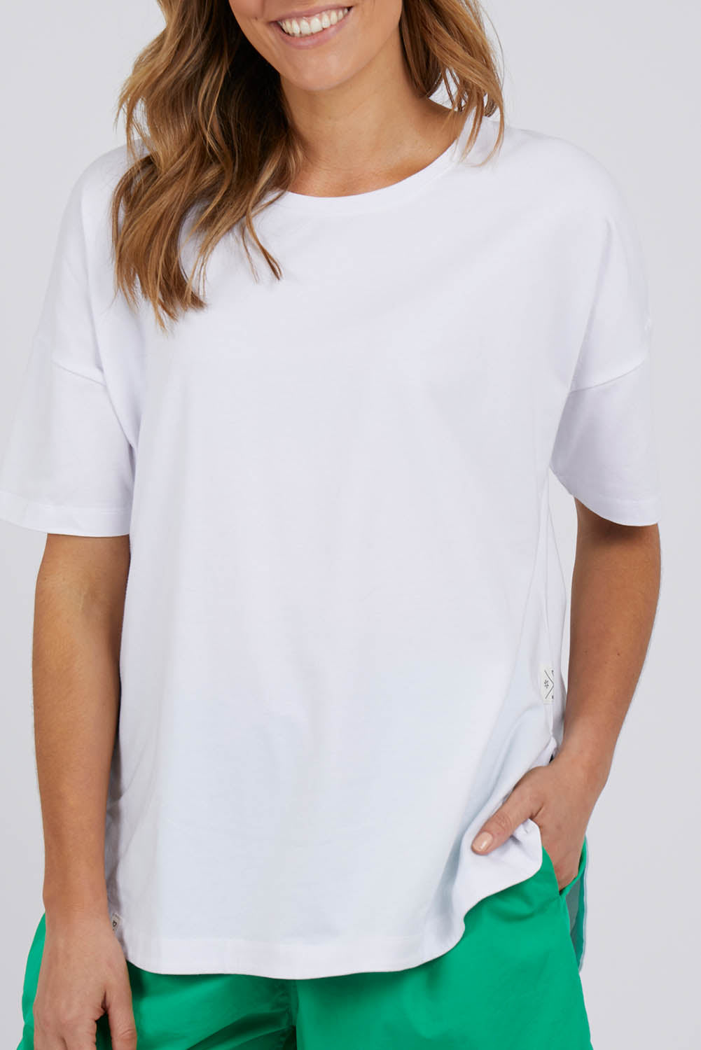 A model wearing the Fundamental Soceity S/S Tee in colour White (White), from the front, cropped image
