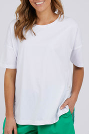 A model wearing the Fundamental Soceity S/S Tee in colour White (White), from the front, cropped image