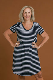 Model Sandy wearing size 10 of the Fundamental Mary Stripe Dress in colour Navy (Blue), from the front, cropped image