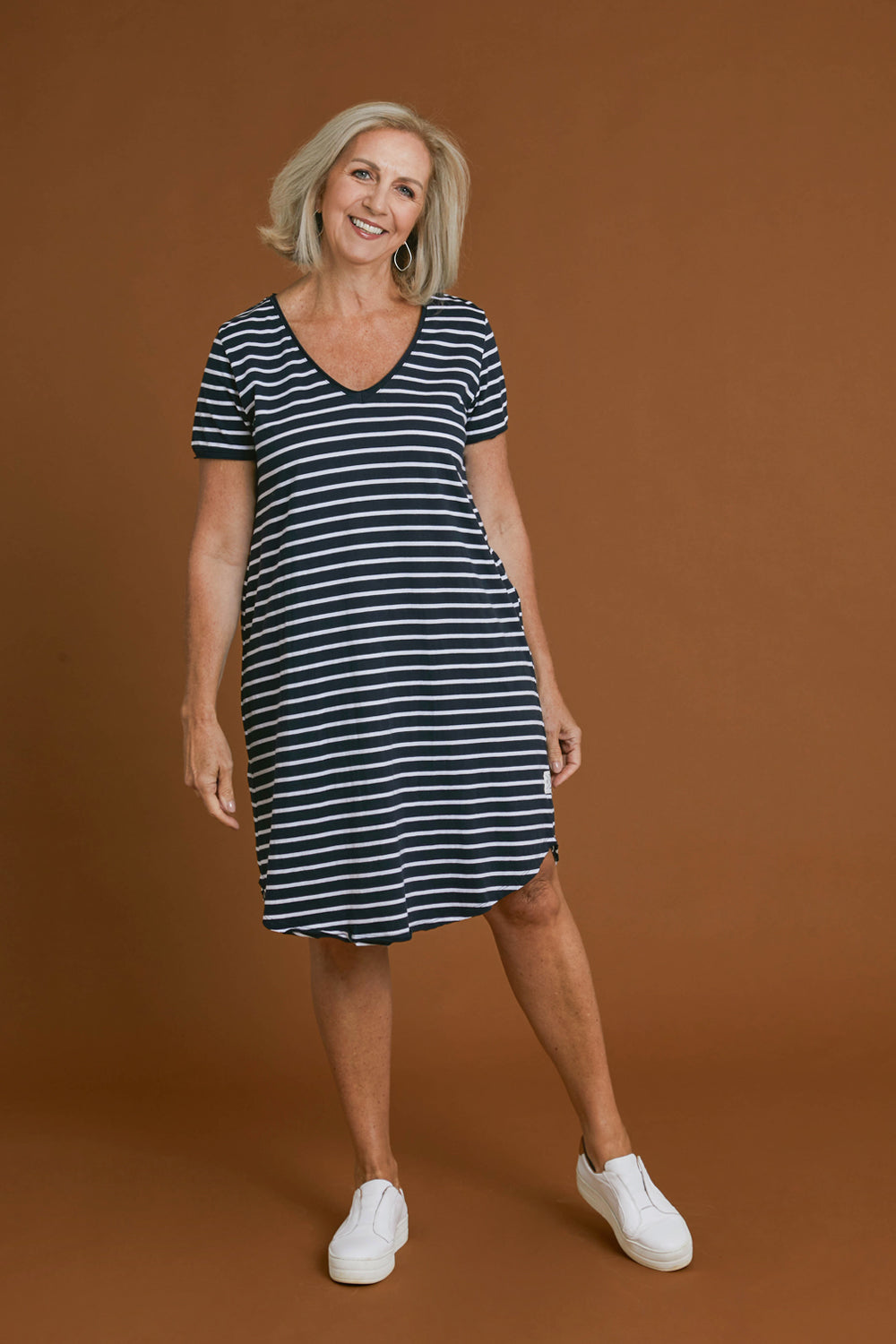 Model Sandy wearing size 10 of the Fundamental Mary Stripe Dress in colour Navy (Blue), from the front, showing the whole outfit