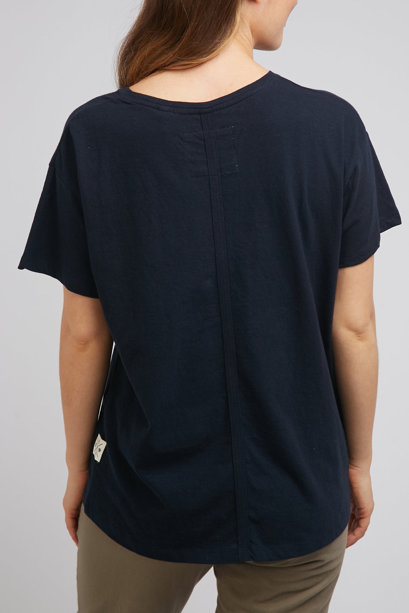 A model wearing the Fundamental Clover Tee in colour Navy (Blue), from the back