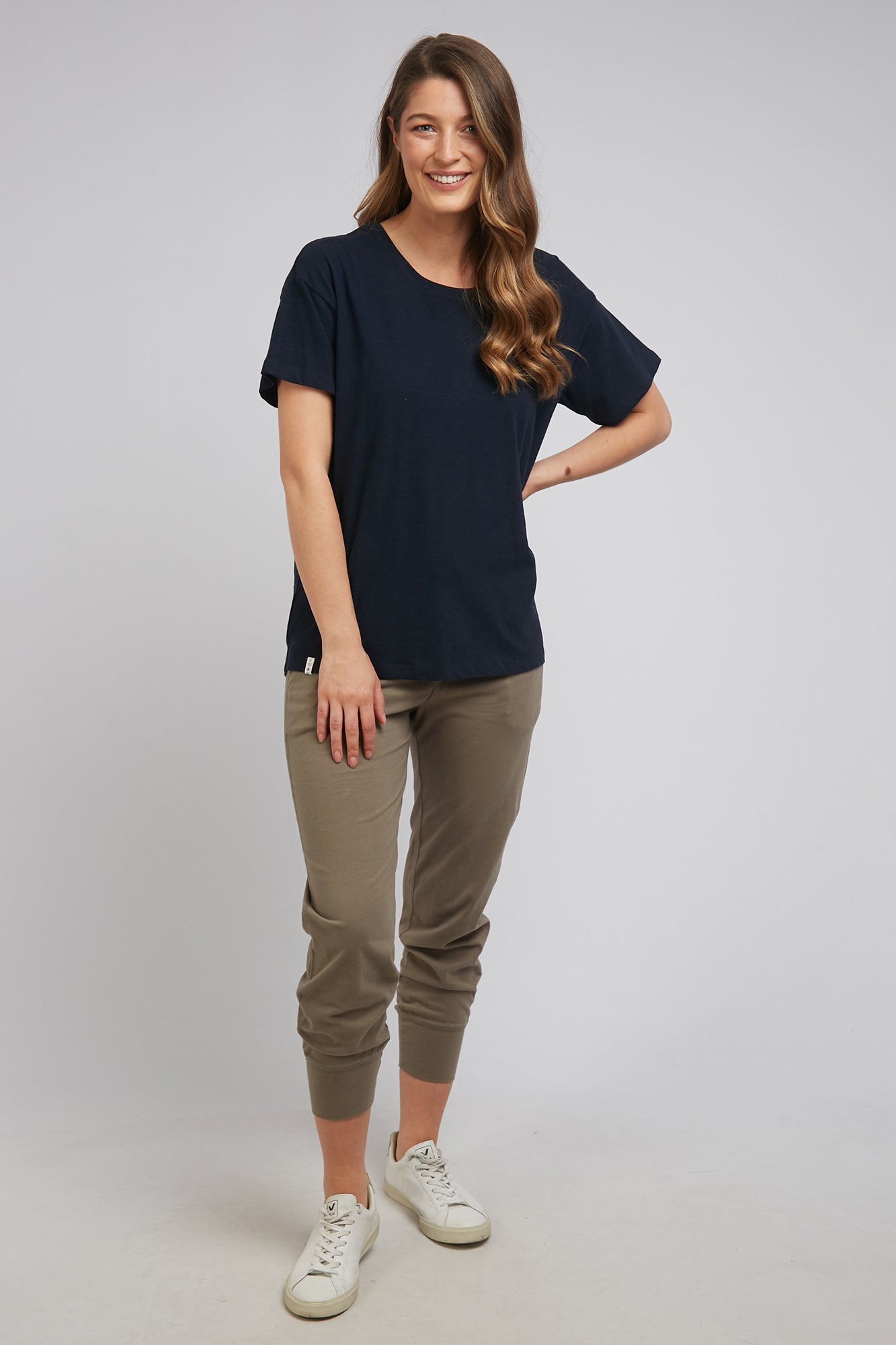 A model wearing the Fundamental Clover Tee in colour Navy (Blue), from the front, showing the whole outfit