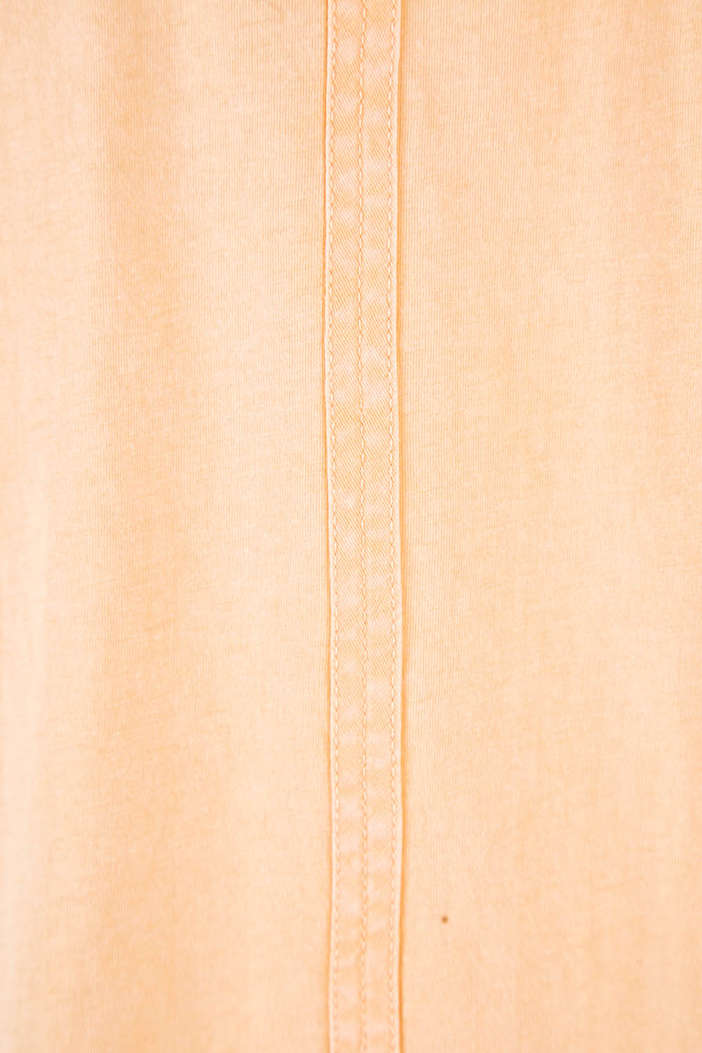 Product shot of the Fundamental Cloud Vee Tee in colour Papaya, detail