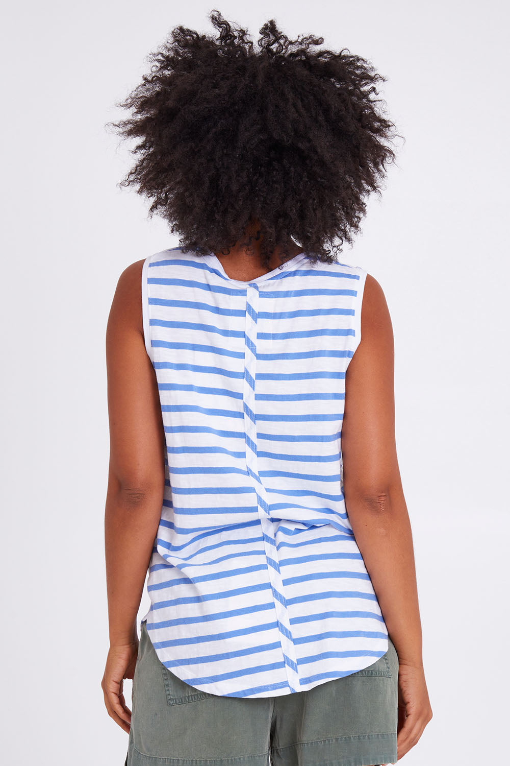 Model Olivia wearing size 10 of the Fundamental Scoop Tank in colour Cornflwhit (Blue), from the back