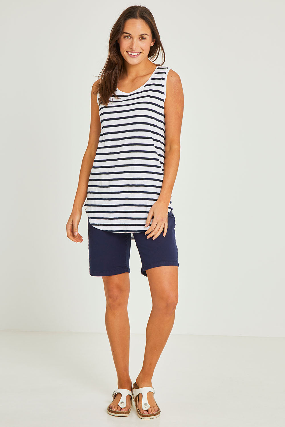 Model Elhana wearing size 10 of the Fundamental Scoop Tank in colour Navywhit (Blue), from the front, showing the whole outfit