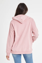 Model Madeline wearing size 10 of the Fundamentals Cosy Hoody in colour Dustypnk (Pink), from the back