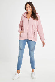 Model Madeline wearing size 10 of the Fundamentals Cosy Hoody in colour Dustypnk (Pink), from the front, showing the whole outfit