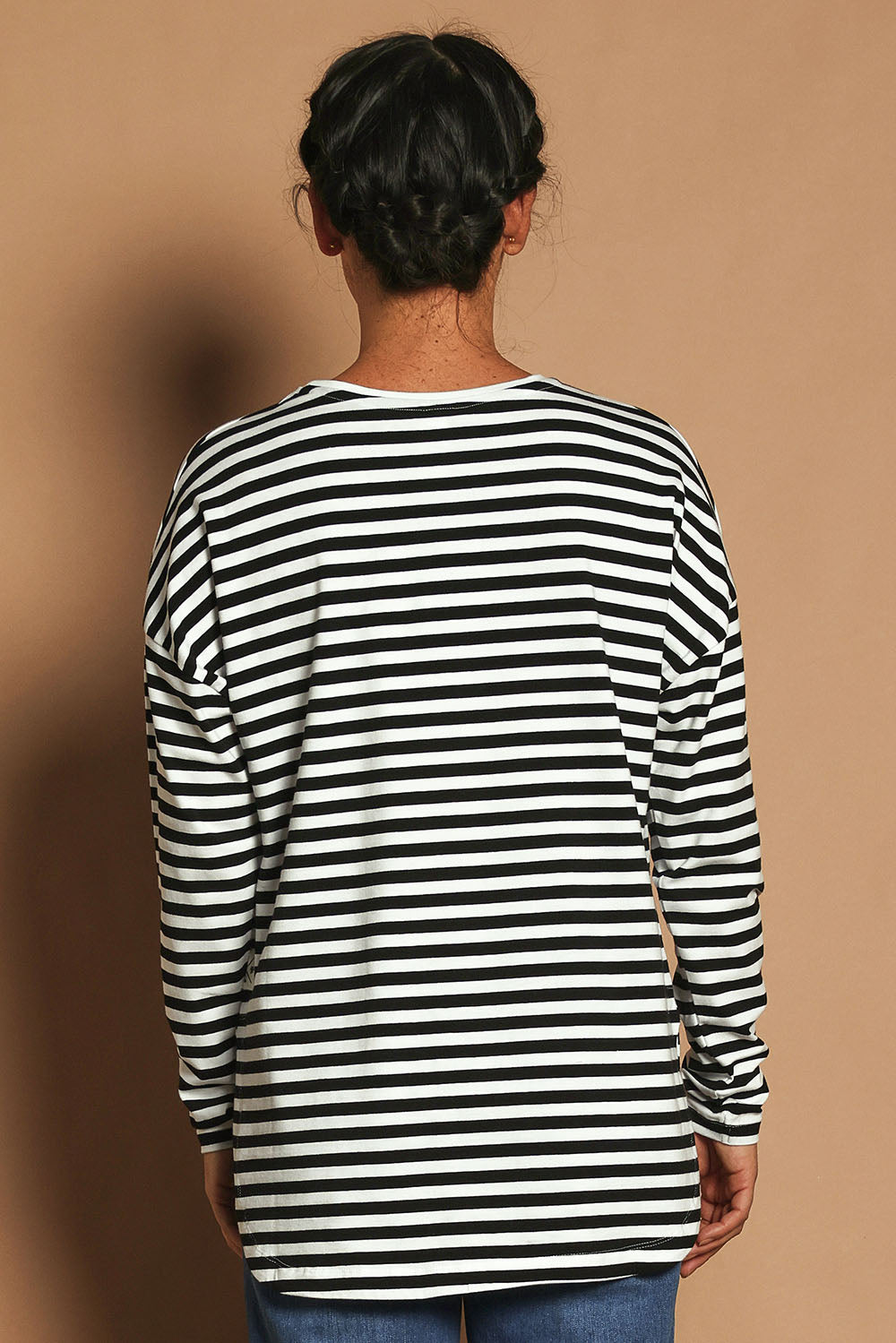 Model Katie wearing size 10 of the Fundamental Lauren Stripe LS Tee in colour Blkwhte (Black), from the back