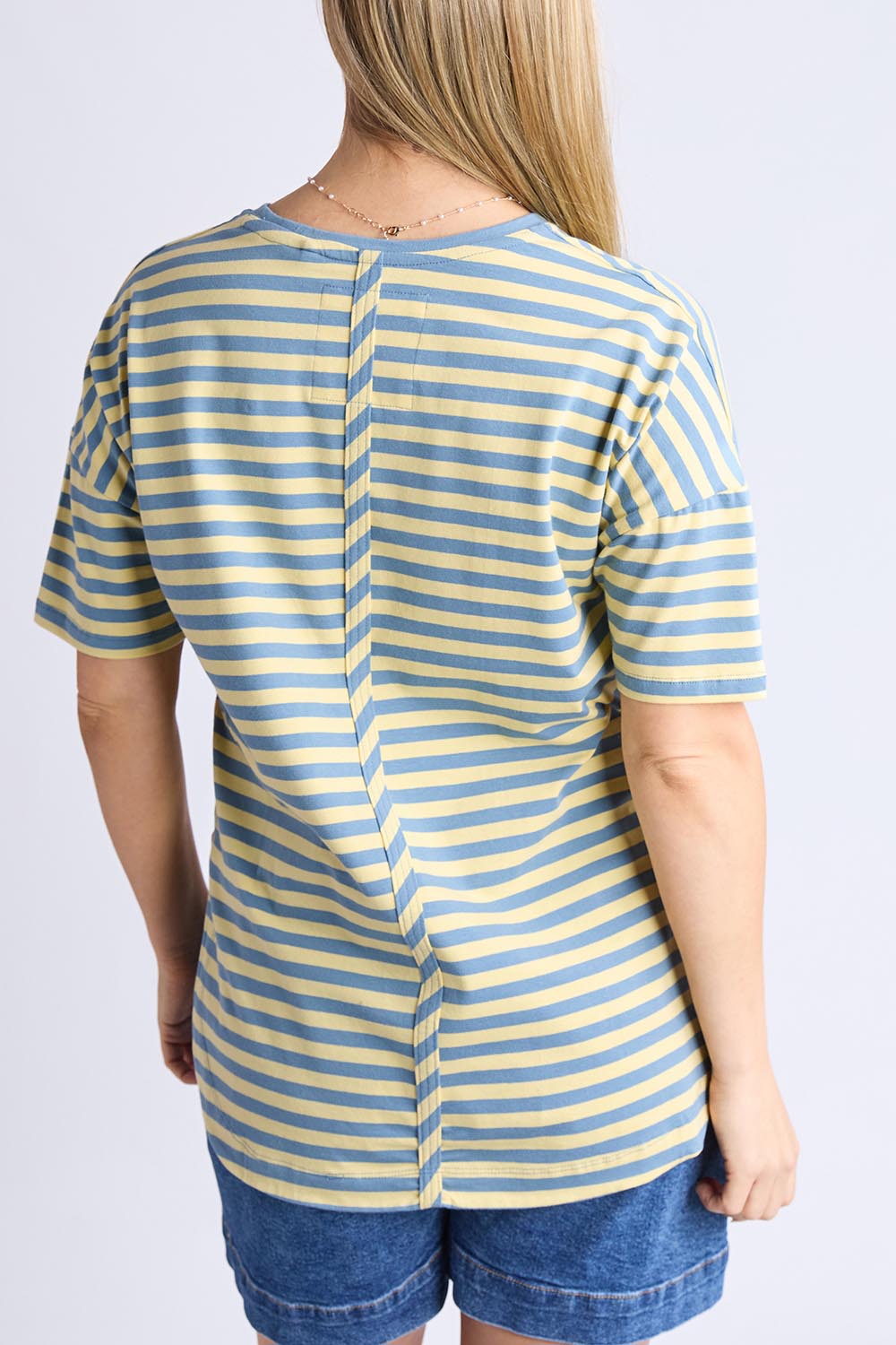 A model wearing the Fundamental Lauren S/S Cotton Stripe in colour Bluebanana (Blue), from the back