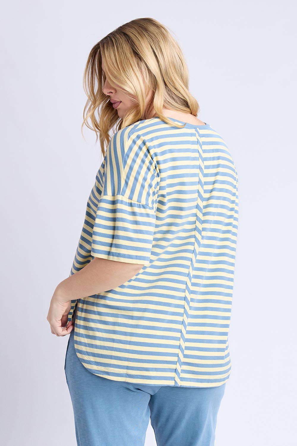 A model wearing the Fundamental Lauren S/S Cotton Stripe in colour Bluebanana (Blue), from the back