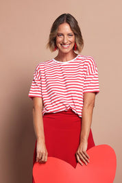 Model Riina wearing size 10 of the Fundamental Lauren S/S Cotton Stripe in colour Cayannewht (Red), from the front, cropped image