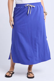A model wearing the Fundamental Travel Skirt in colour Oceanblue (Blue), from the front, cropped image