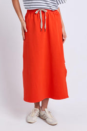 Model Genericm wearing size sample of the Fundamental Travel Skirt – Tangello in colour Tangello, from the front