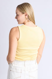 A model wearing the Fundamental Rib Crew Cotton Tank in colour Banana, from the back