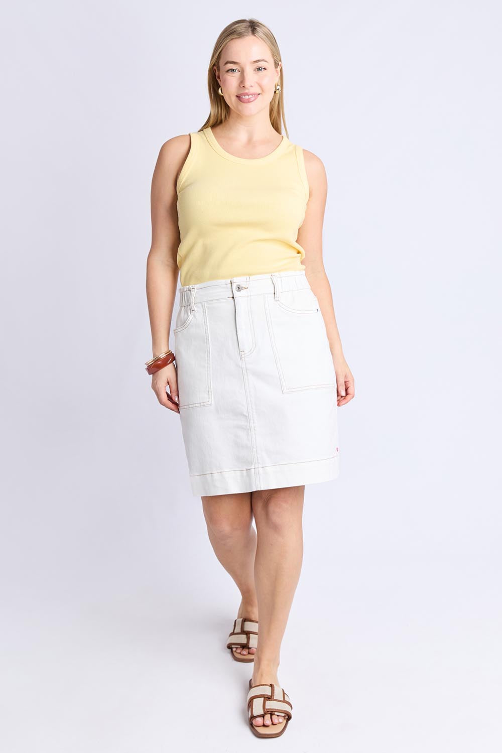A model wearing the Fundamental Rib Crew Cotton Tank in colour Banana, from the front, showing the whole outfit