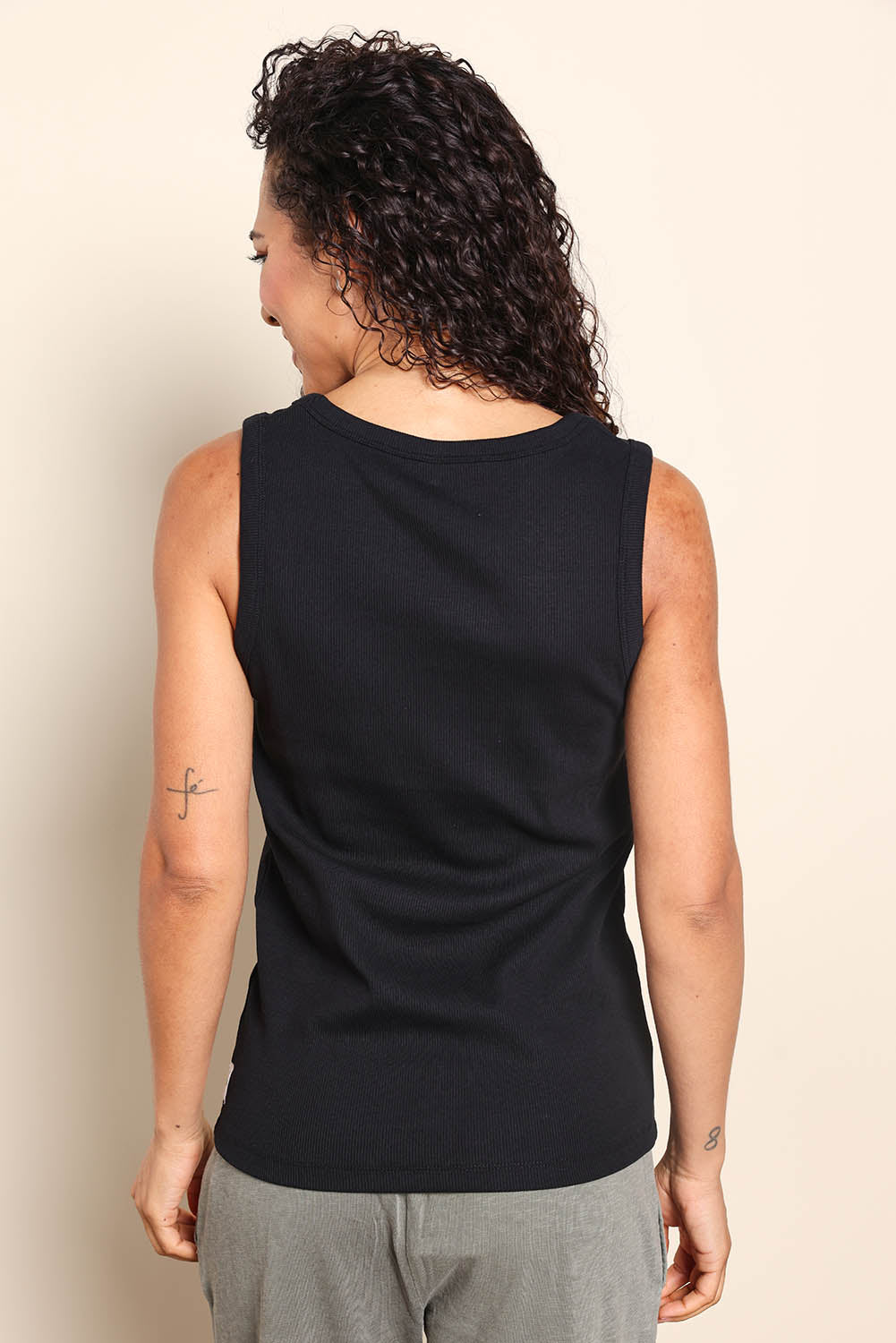 Model Pamelar wearing size 10 of the Fundamental Rib Crew Cotton Tank - Black in colour Black, from the back