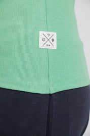 A model wearing the Fundamental Rib Crew Cotton Tank in colour Meadow (Green), from the front, cropped image