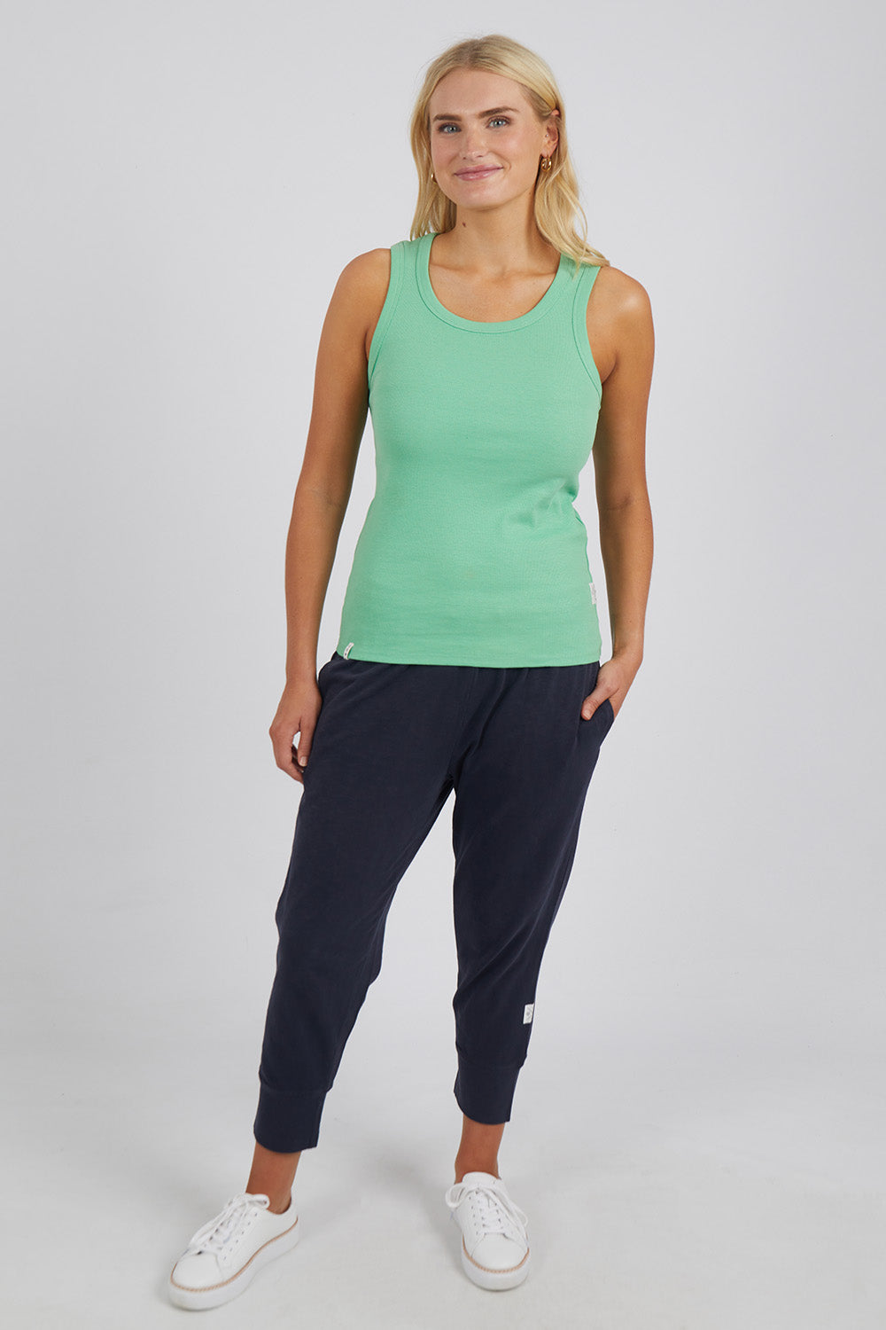 A model wearing the Fundamental Rib Crew Cotton Tank in colour Meadow (Green), from the front, showing the whole outfit