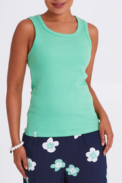 Model Olivia wearing size 10 of the Fundamental Rib Crew Cotton Tank in colour Meadow (Green), from the front, cropped image