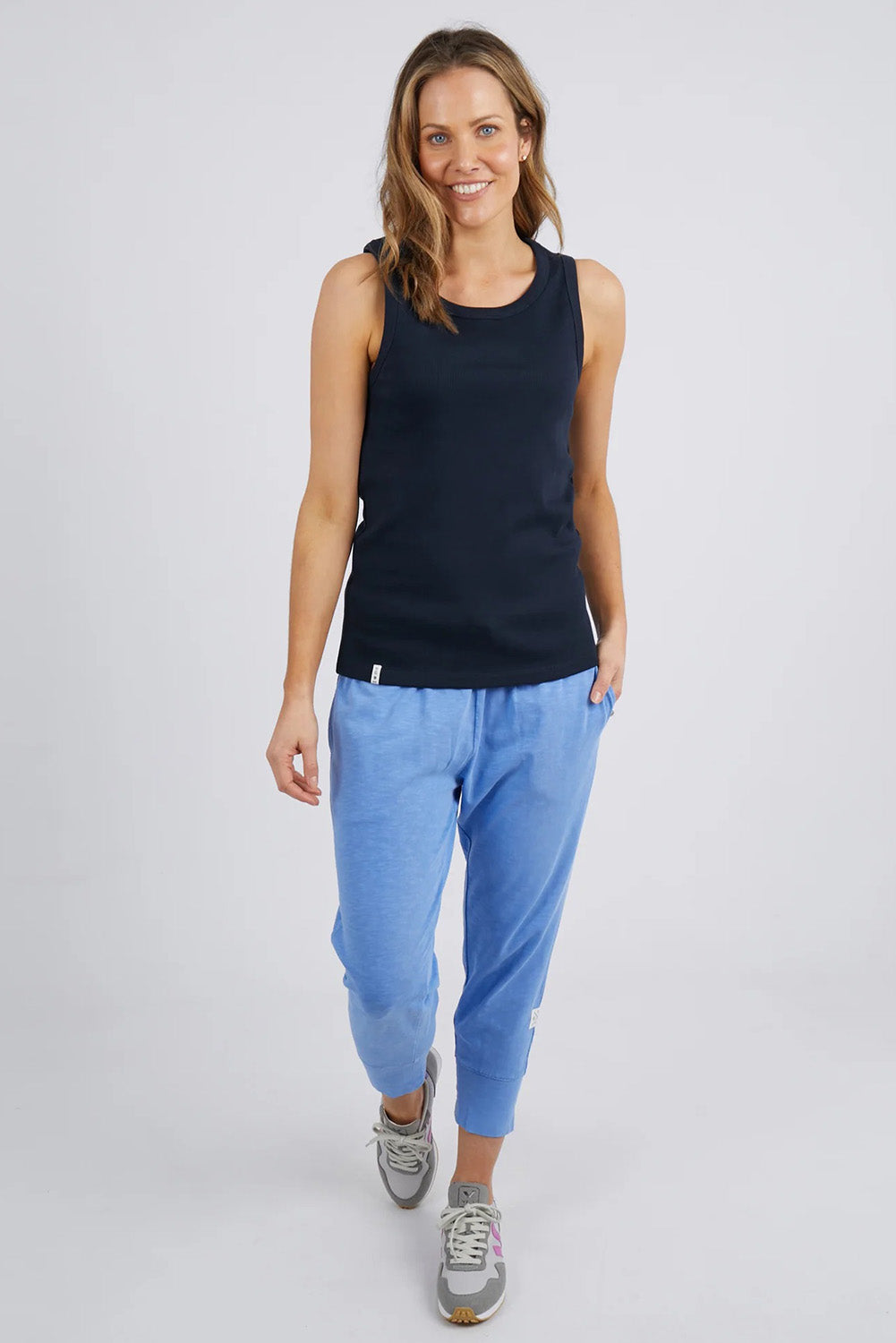 A model wearing the Fundamental Rib Crew Cotton Tank in colour Navy (Blue), from the front, showing the whole outfit