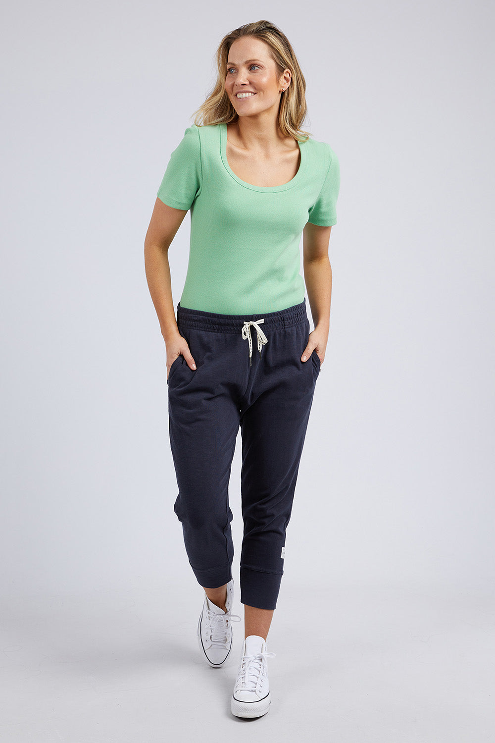 A model wearing the Fundamental Rib Scoop S/S  Tee in colour Meadow (Green), from the front, showing the whole outfit