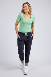 A model wearing the Fundamental Rib Scoop S/S  Tee in colour Meadow (Green), from the front, showing the whole outfit