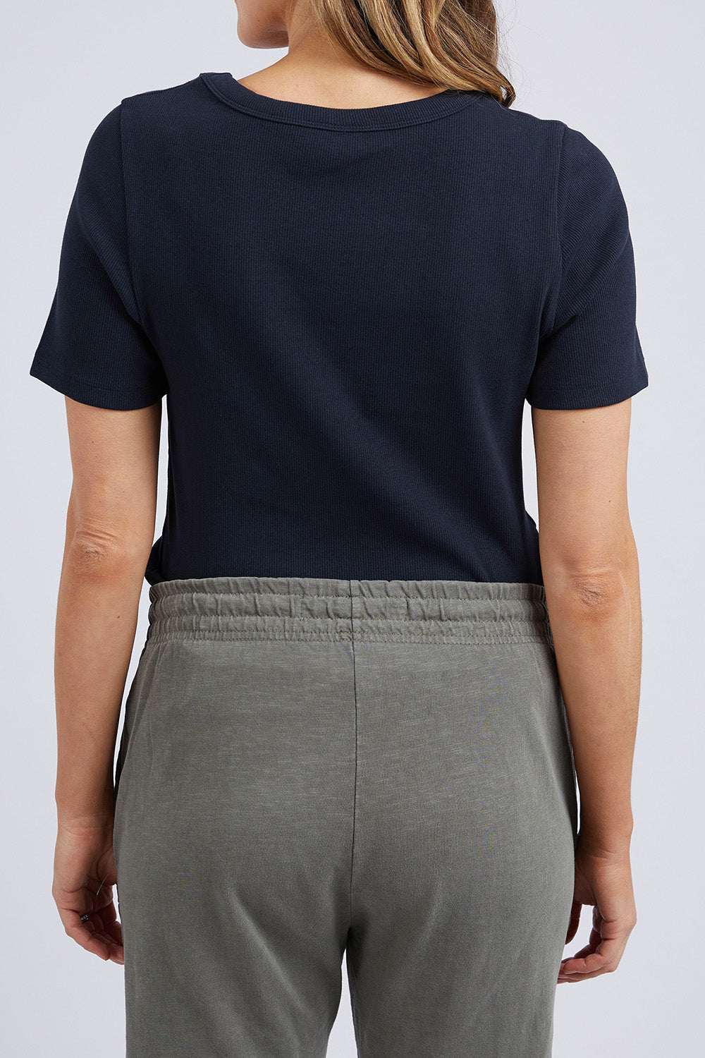 A model wearing the Fundamental Rib Scoop S/S  Tee in colour Navy (Blue), from the back