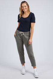 A model wearing the Fundamental Rib Scoop S/S  Tee in colour Navy (Blue), from the front, showing the whole outfit