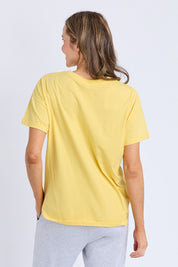 A model wearing the Fundamental Halli Cotton Tee in colour Lemon, from the back