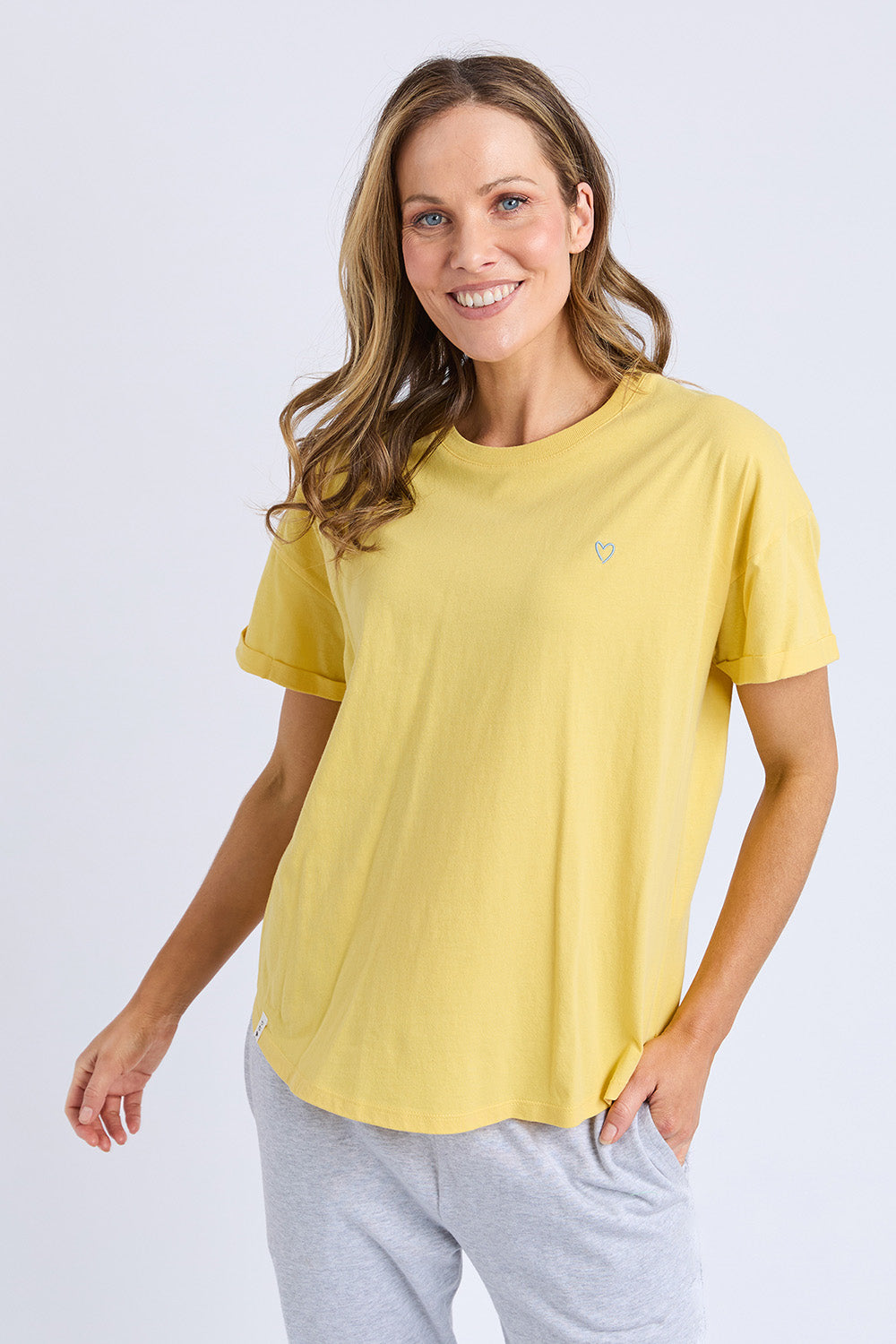 A model wearing the Fundamental Halli Cotton Tee in colour Lemon, from the front, cropped image