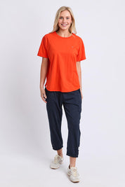 Model Genericm wearing size sample of the Fundamental Halli Cotton Tee – Tangello in colour Tangello, from the front