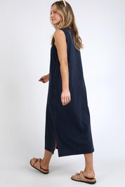 A model wearing the Fundamental Elysian Cotton Dress in colour Navy (Black), from the back