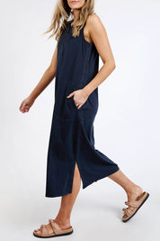 A model wearing the Fundamental Elysian Cotton Dress in colour Navy (Black), from the front, cropped image