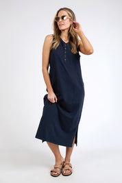 A model wearing the Fundamental Elysian Cotton Dress in colour Navy (Black), from the front, showing the whole outfit