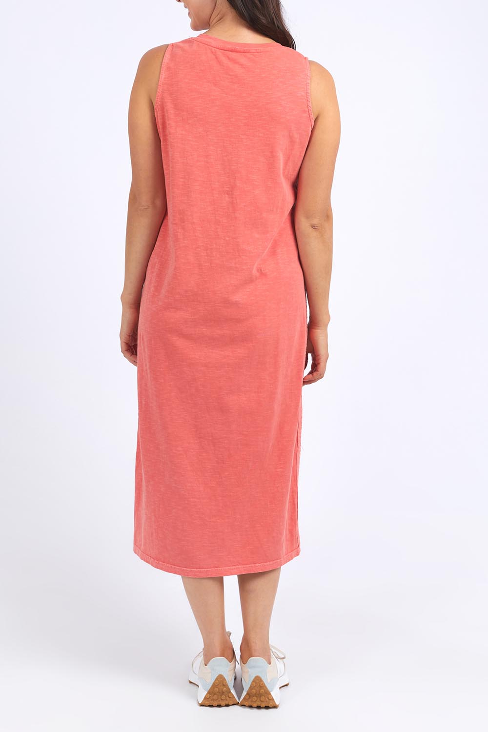 A model wearing the Fundamental Elysian Cotton Dress in colour Watermelon (Red), from the back