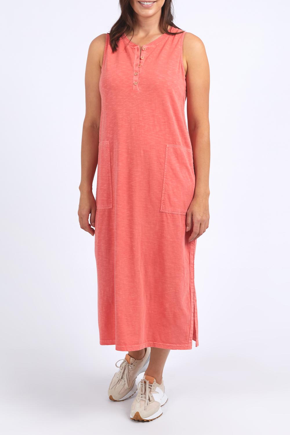 A model wearing the Fundamental Elysian Cotton Dress in colour Watermelon (Red), from the front, cropped image