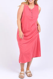 A model wearing the Fundamental Elysian Cotton Dress in colour Watermelon (Red), from the front, cropped image