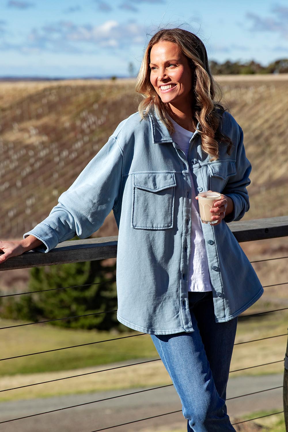 A model wearing the Fundamental Poppy Cotton Fleece Shacket in colour Steelblue (Blue), from the front, showing the whole outfit