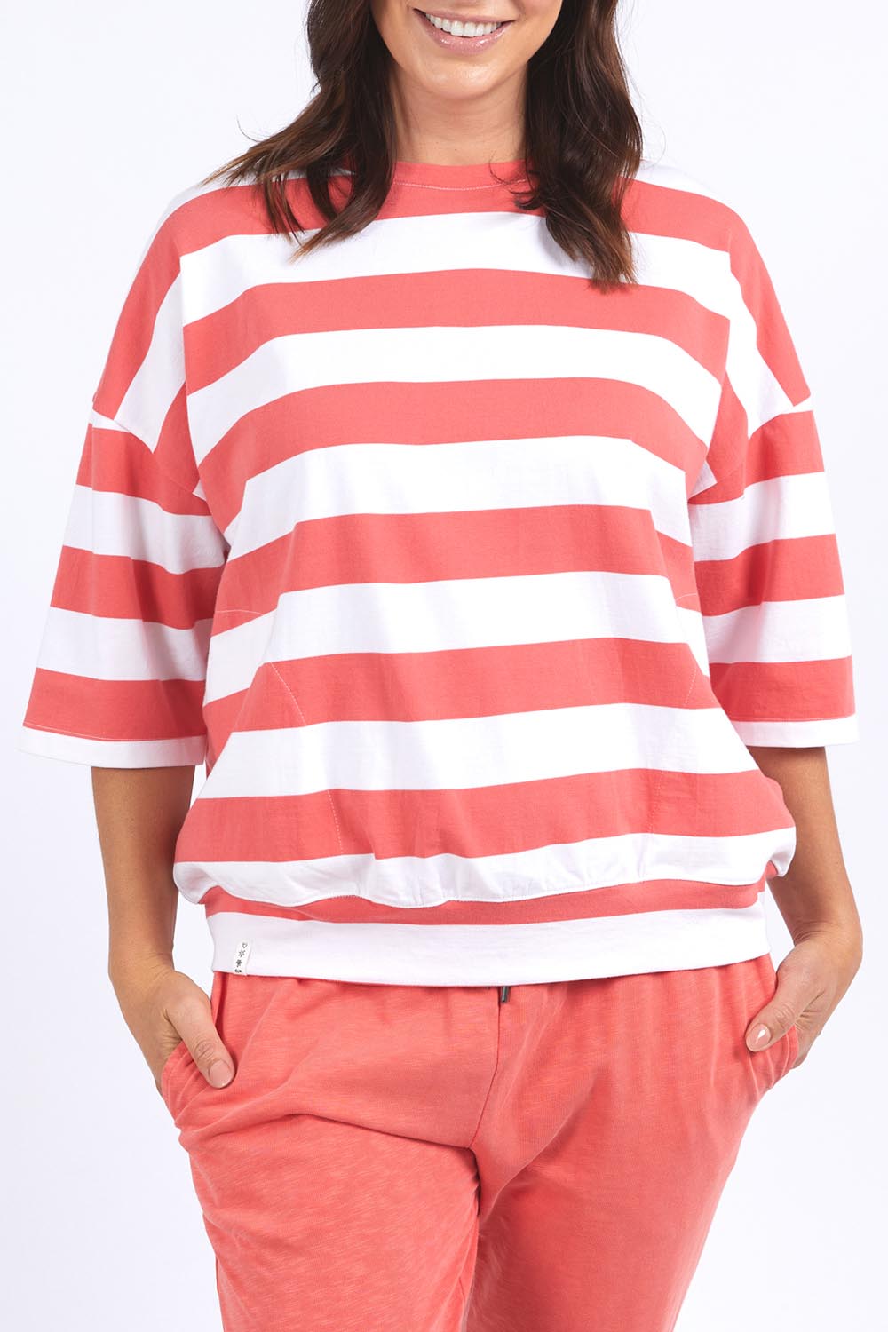 A model wearing the Fundamental Mazie Block Stripe Cotton Sweat in colour Watermelon (Red), from the front, cropped image