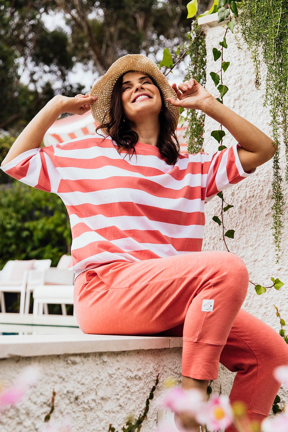 A model wearing the Fundamental Mazie Block Stripe Cotton Sweat in colour Watermelon (Red), from the front, showing the whole outfit