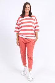 A model wearing the Fundamental Mazie Block Stripe Cotton Sweat in colour Watermelon (Red), from the front, showing the whole outfit