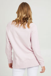 Model Grace wearing size 10 of the Fundamental Melbourne Crew in colour Powderpnk (Pink), from the back