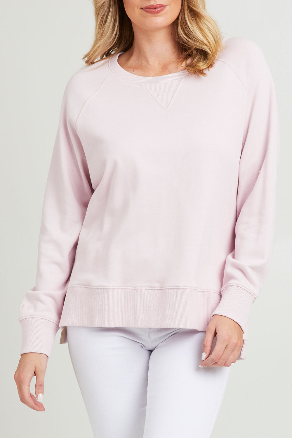 Model Grace wearing size 10 of the Fundamental Melbourne Crew in colour Powderpnk (Pink), from the front, cropped image