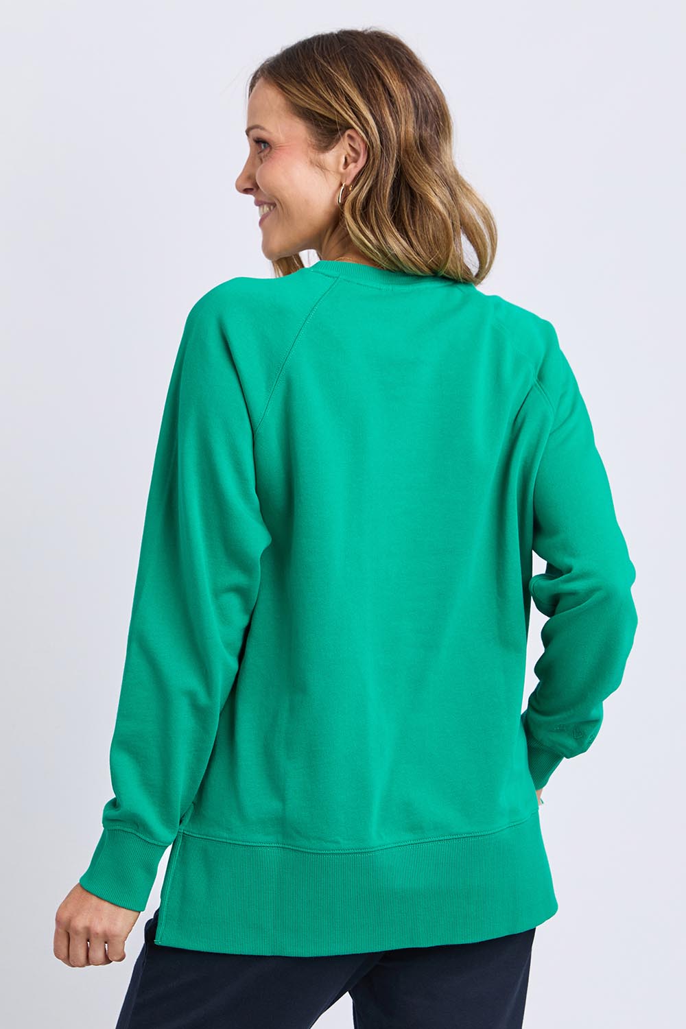 A model wearing the Fundamental Melbourne Crew in colour Turquoise (Green), from the back