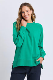 A model wearing the Fundamental Melbourne Crew in colour Turquoise (Green), from the front, cropped image