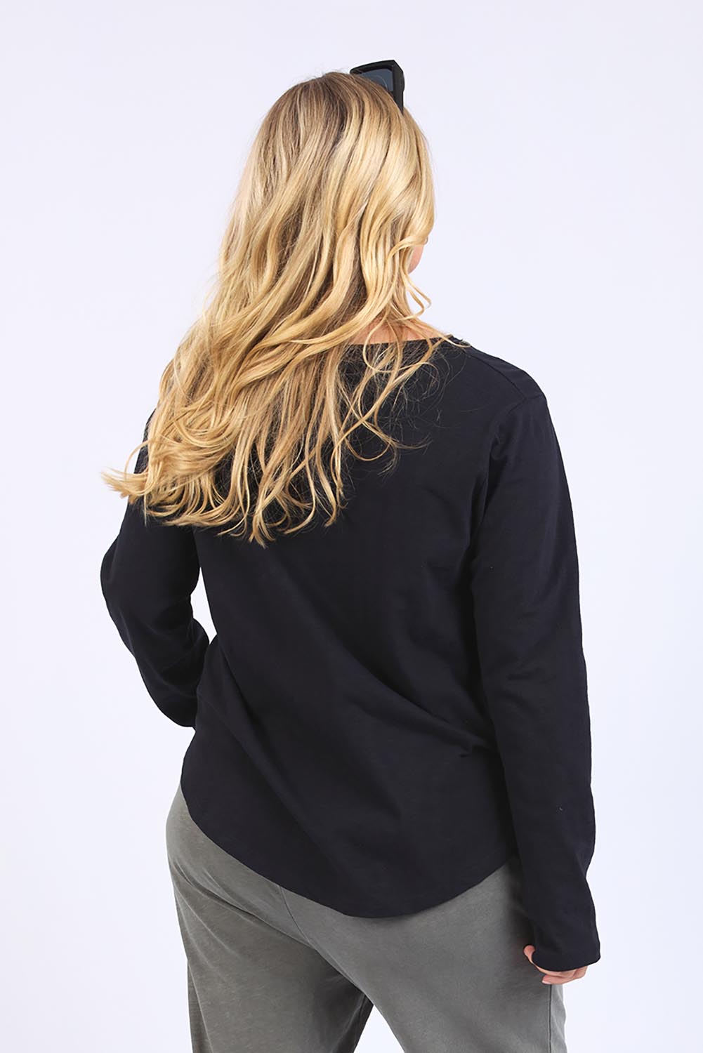 A model wearing the Fundamental Everyday Cotton Long Sleeve Tee in colour Black (Black), from the back